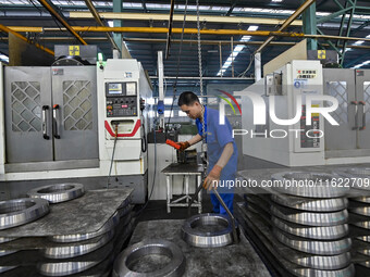 A worker works at an auto gear manufacturing company in Qingzhou Economic Development Zone in Qingzhou, China, on September 30, 2024. On the...