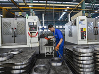 A worker works at an auto gear manufacturing company in Qingzhou Economic Development Zone in Qingzhou, China, on September 30, 2024. On the...