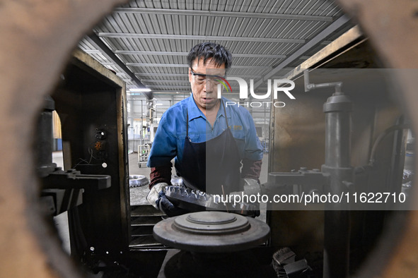 A worker works at an auto gear manufacturing company in Qingzhou Economic Development Zone in Qingzhou, China, on September 30, 2024. On the...