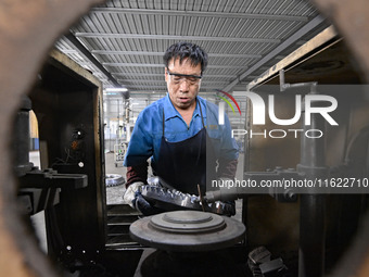 A worker works at an auto gear manufacturing company in Qingzhou Economic Development Zone in Qingzhou, China, on September 30, 2024. On the...