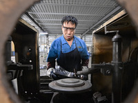 A worker works at an auto gear manufacturing company in Qingzhou Economic Development Zone in Qingzhou, China, on September 30, 2024. On the...