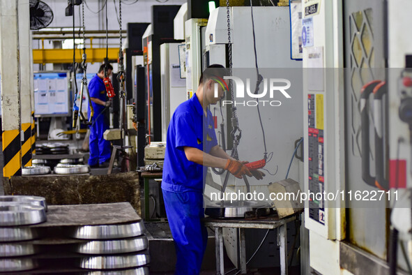 A worker works at an auto gear manufacturing company in Qingzhou Economic Development Zone in Qingzhou, China, on September 30, 2024. On the...