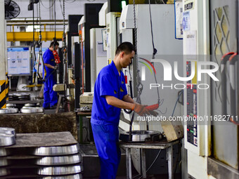 A worker works at an auto gear manufacturing company in Qingzhou Economic Development Zone in Qingzhou, China, on September 30, 2024. On the...