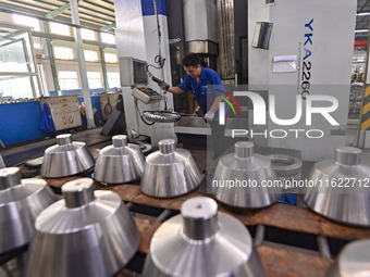 A worker works at an auto gear manufacturing company in Qingzhou Economic Development Zone in Qingzhou, China, on September 30, 2024. On the...