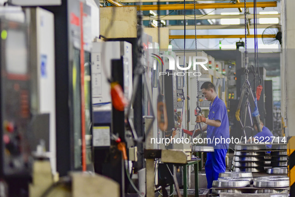 A worker works at an auto gear manufacturing company in Qingzhou Economic Development Zone in Qingzhou, China, on September 30, 2024. On the...