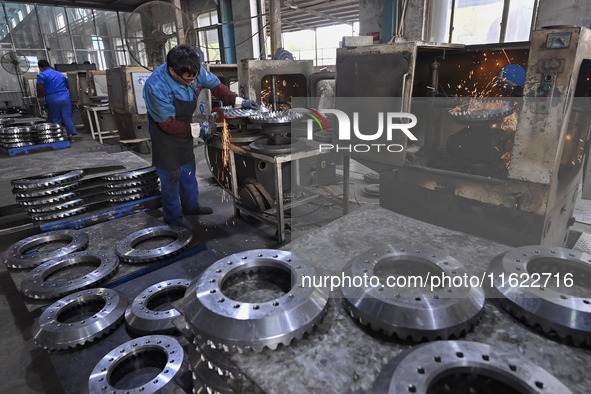 A worker works at an auto gear manufacturing company in Qingzhou Economic Development Zone in Qingzhou, China, on September 30, 2024. On the...