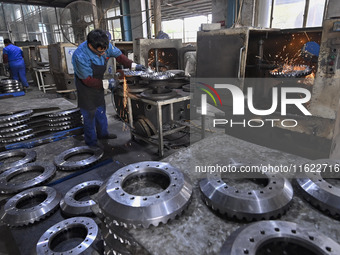 A worker works at an auto gear manufacturing company in Qingzhou Economic Development Zone in Qingzhou, China, on September 30, 2024. On the...