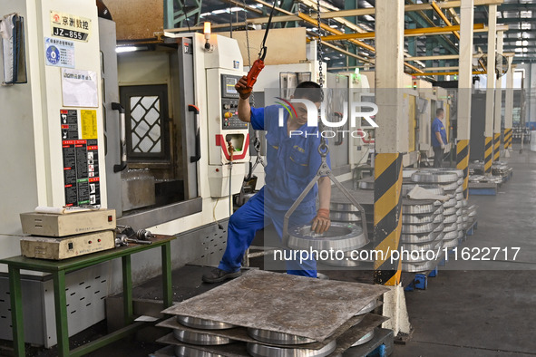 A worker works at an auto gear manufacturing company in Qingzhou Economic Development Zone in Qingzhou, China, on September 30, 2024. On the...