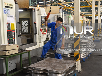 A worker works at an auto gear manufacturing company in Qingzhou Economic Development Zone in Qingzhou, China, on September 30, 2024. On the...