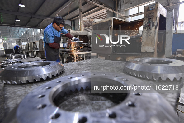 A worker works at an auto gear manufacturing company in Qingzhou Economic Development Zone in Qingzhou, China, on September 30, 2024. On the...