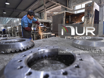 A worker works at an auto gear manufacturing company in Qingzhou Economic Development Zone in Qingzhou, China, on September 30, 2024. On the...