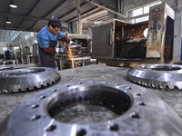 A worker works at an auto gear manufacturing company in Qingzhou Economic Development Zone in Qingzhou, China, on September 30, 2024. On the...