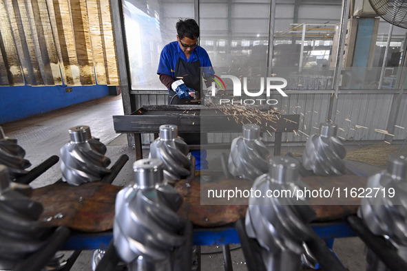 A worker works at an auto gear manufacturing company in Qingzhou Economic Development Zone in Qingzhou, China, on September 30, 2024. On the...