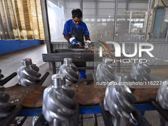 A worker works at an auto gear manufacturing company in Qingzhou Economic Development Zone in Qingzhou, China, on September 30, 2024. On the...