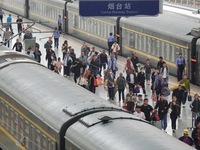 Passengers get off the train at Yantai Station in Yantai, China, on September 30, 2024. According to the China National Railway Group Co., L...