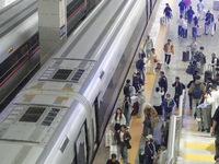 Passengers take a train at Yantai Station in Yantai, China, on September 30, 2024. According to the China National Railway Group Co., LTD.,...