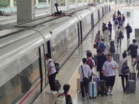 Passengers take a train at Yantai Station in Yantai, China, on September 30, 2024. According to the China National Railway Group Co., LTD.,...