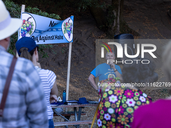 Napa community members participate in the inaugural Napa Day Against Hate at Westwood Hills Park, in Napa, Calif., on July 29, 2024. Dr. Pet...