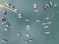 An aerial view shows boatmen navigating their vessel across the Shitalakshya River, carrying passengers from Bandar Ghat in Narayanganj, Ban...