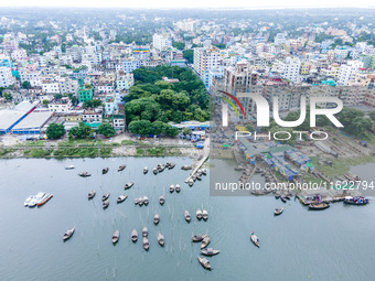 An aerial view shows boatmen navigating their vessel across the Shitalakshya River, carrying passengers from Bandar Ghat in Narayanganj, Ban...