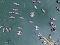 An aerial view shows boatmen navigating their vessel across the Shitalakshya River, carrying passengers from Bandar Ghat in Narayanganj, Ban...