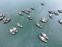 An aerial view shows boatmen navigating their vessel across the Shitalakshya River, carrying passengers from Bandar Ghat in Narayanganj, Ban...