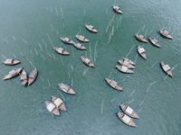 An aerial view shows boatmen navigating their vessel across the Shitalakshya River, carrying passengers from Bandar Ghat in Narayanganj, Ban...