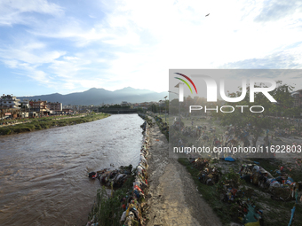 Plastics remain entangled in the branches of trees and infrastructures along the embankments of the Bagmati River in Kathmandu, Nepal, on Se...