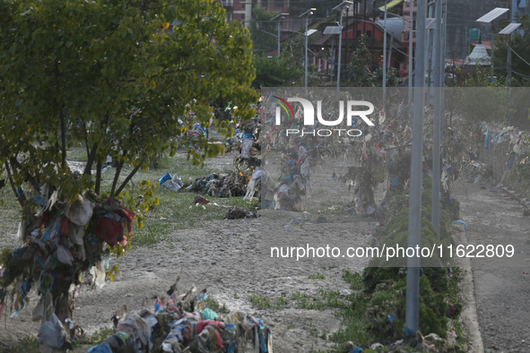 Plastics remain entangled in the branches of trees and infrastructures along the embankments of the Bagmati River in Kathmandu, Nepal, on Se...