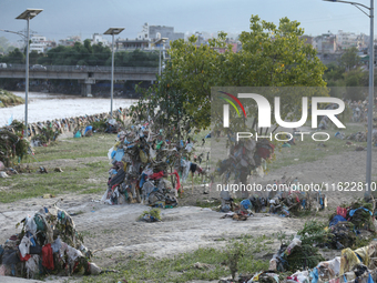 Plastics remain entangled in the branches of trees and infrastructures along the embankments of the Bagmati River in Kathmandu, Nepal, on Se...