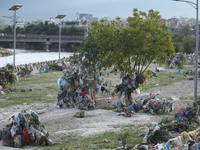 Plastics remain entangled in the branches of trees and infrastructures along the embankments of the Bagmati River in Kathmandu, Nepal, on Se...