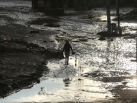 A man walks along the embankments of the Bagmati River along the trails of dumped plastics after flooding in Kathmandu, Nepal, on September...