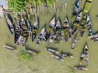 An aerial view shows traders selling fruits and vegetables from boats at Boithakata floating market on the Belua River in Pirojpur, Barisal,...