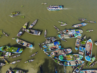 An aerial view shows traders selling fruits and vegetables from boats at Boithakata floating market on the Belua River in Pirojpur, Barisal,...