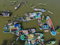 An aerial view shows traders selling fruits and vegetables from boats at Boithakata floating market on the Belua River in Pirojpur, Barisal,...