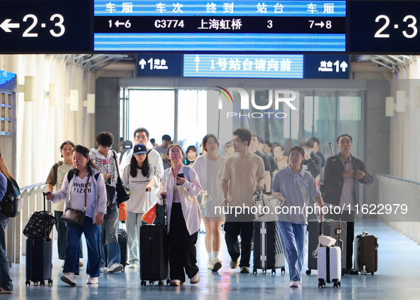 Passengers travel at Nanjing Railway Station in Nanjing, China, on September 30, 2024. 