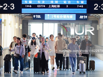 Passengers travel at Nanjing Railway Station in Nanjing, China, on September 30, 2024. (