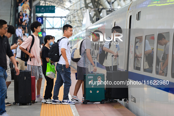 Passengers travel at Nanjing Railway Station in Nanjing, China, on September 30, 2024. 