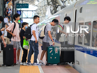 Passengers travel at Nanjing Railway Station in Nanjing, China, on September 30, 2024. (