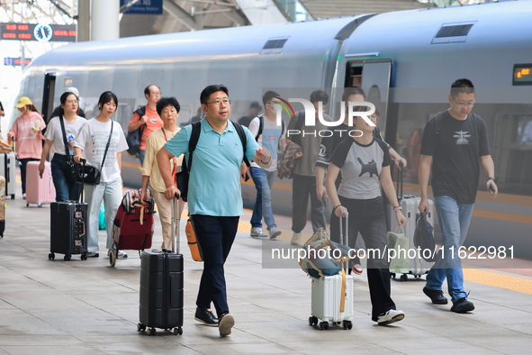 Passengers travel at Nanjing Railway Station in Nanjing, China, on September 30, 2024. 