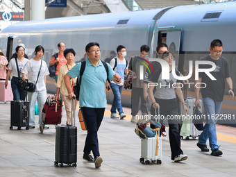 Passengers travel at Nanjing Railway Station in Nanjing, China, on September 30, 2024. (