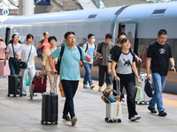 Passengers travel at Nanjing Railway Station in Nanjing, China, on September 30, 2024. (