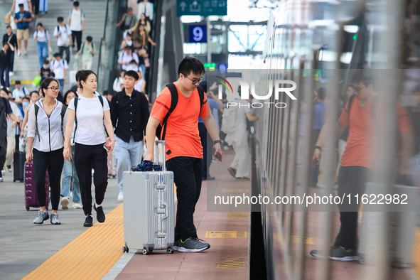 Passengers travel at Nanjing Railway Station in Nanjing, China, on September 30, 2024. 