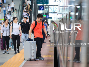 Passengers travel at Nanjing Railway Station in Nanjing, China, on September 30, 2024. (