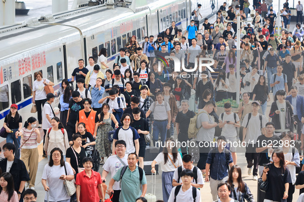 Passengers travel at Nanjing Railway Station in Nanjing, China, on September 30, 2024. 