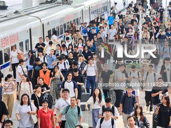 Passengers travel at Nanjing Railway Station in Nanjing, China, on September 30, 2024. (