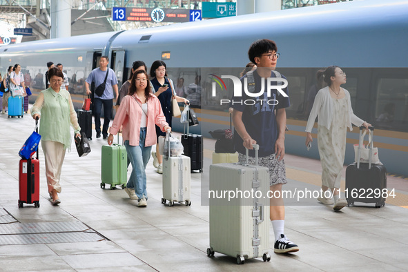 Passengers travel at Nanjing Railway Station in Nanjing, China, on September 30, 2024. 