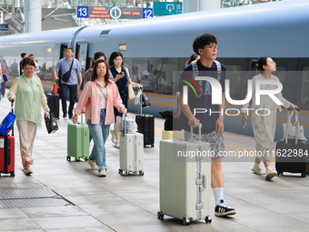 Passengers travel at Nanjing Railway Station in Nanjing, China, on September 30, 2024. (