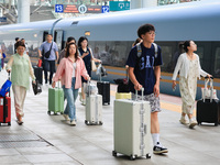 Passengers travel at Nanjing Railway Station in Nanjing, China, on September 30, 2024. (