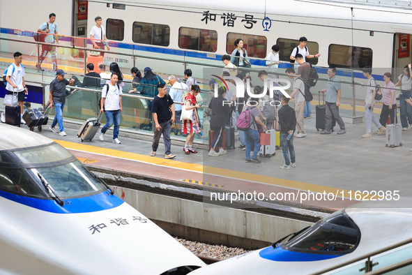 Passengers travel at Nanjing Railway Station in Nanjing, China, on September 30, 2024. 